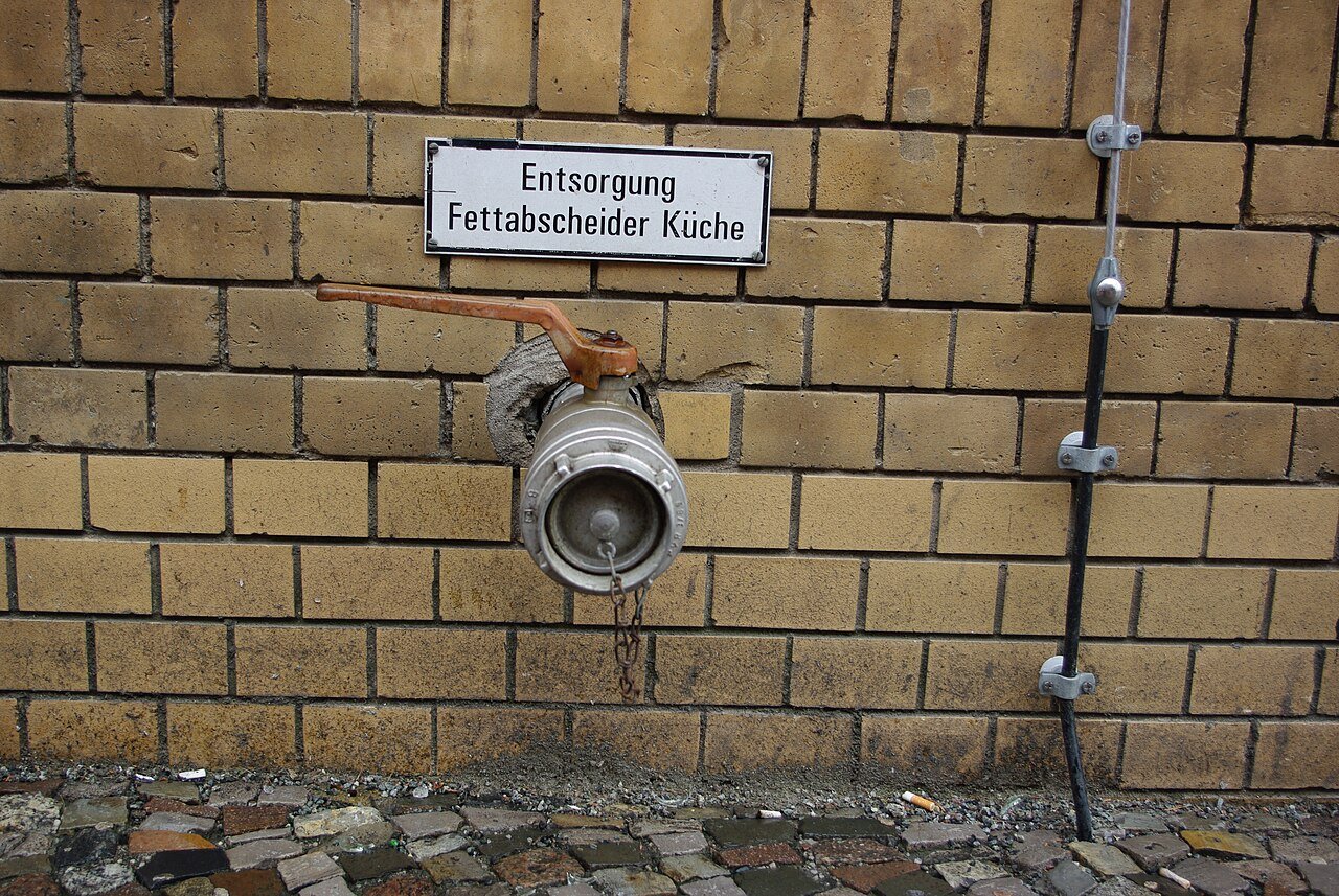 Stainless steel grease separator unit installed in a building basement